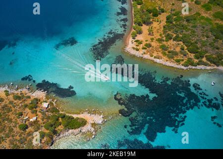 Aerial view of blue sea and speed boat sailing along the mediterranean coast. Landscape of turkish riviera nature Stock Photo