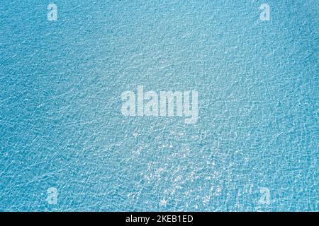 Paradise clear water surface view. Blue liquid texture of wavy lake or sea with transparent water Stock Photo