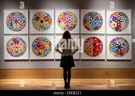 London, UK.  11 November 2022. A staff member views ‘Flower Ball (3D)', 2007-2014, by Takashi Murakami (Est. £7,000 - £10,000) at a preview of ‘The Astute Eye’ at Bonhams, a sale of contemporary artworks offered by a private London collector.  The auction takes place online through to 17 November at Bonhams New Bond Street galleries.  Credit: Stephen Chung / Alamy Live News Stock Photo