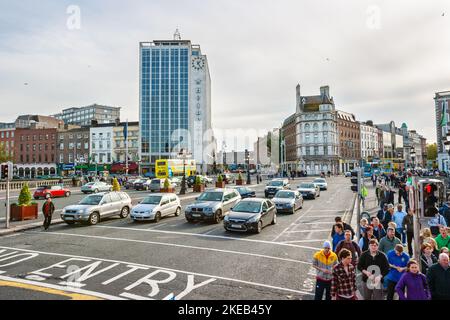 Cars and pedestrians crossing the O'Connell Bridge in сity сentre. Dublin, Ireland Stock Photo