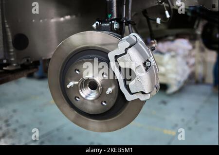 Assembled car suspension with brake mechanism in workshop Stock Photo