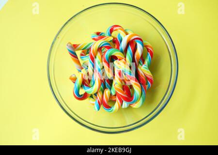 mini cherry candy canes on yellow background  Stock Photo