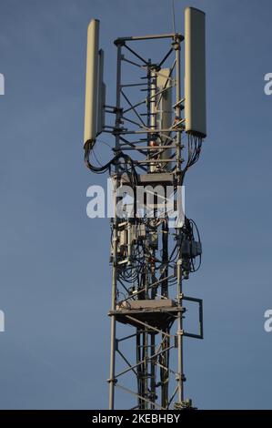 A Telecommunication antenna mast with blue sky background, France Stock Photo