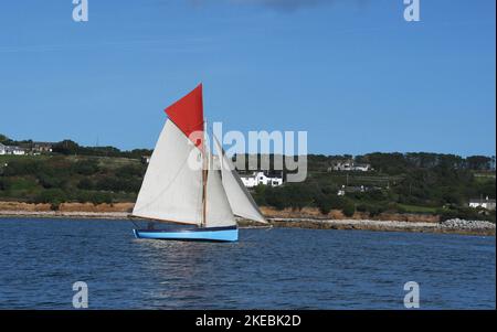 Gaff riggedcutter sailing close to the coast of St Marys, the main island in the Isles of Scilly archepelago, of the tip of Cornwall. Stock Photo