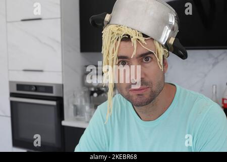 Chaotic chef trying to make some pasta Stock Photo