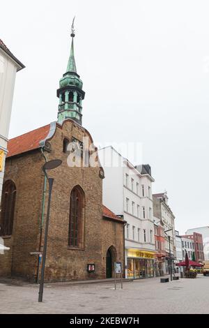 Flensburg, Germany - February 10, 2017: Vertical street view with the Church of the Holy Spirit at Grosse Strasse in Flensburg, this is a shopping str Stock Photo