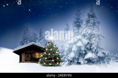 Shiny Christmas tree by a log cabin in the snow Stock Photo