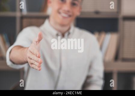 Head shot portrait smiling businessman wearing glasses extending hand for handshake at camera, friendly hr manager greeting candidate on interview, offering deal, welcoming client at meeting Stock Photo