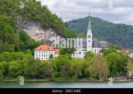 View of lake Bled at in spring and St. Martina Parish church. Bled, Upper Carniola, Slovenia. Stock Photo