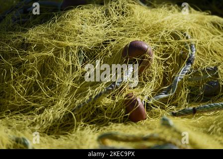 Traditional Greek yellow fishing nets with floats in Kea island, Cyclades Greece. Stock Photo