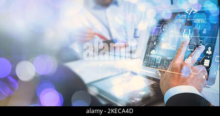 Coding programmer, Digital technology, software development concept.  software engineer working on laptop with circuit board and javascript on virtual Stock Photo