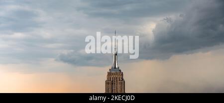 Skyscraper lightning rod on cloudy rainy sky panorama with low hanging clouds Stock Photo