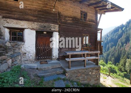 old mountain farmhouse on the steep slope in the South Tyrolean Ulten Valley Stock Photo