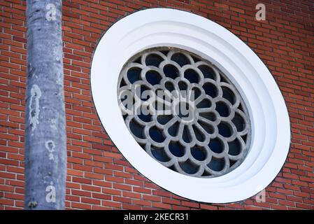 Round Mosaic Decorational Window in the Brick Wall Stock Photo