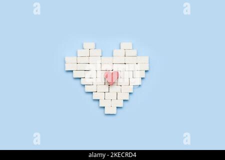 a heart made out of white cubes with a red heart in the middle on a light blue background, Stock Photo