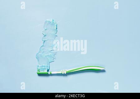 a toothbrush on a light blue background with copy space in the top right hand corner to the left side Stock Photo
