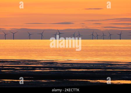 Sun setting over the Kentish Flats Offshore wind farm off the coast of Kent. Stock Photo