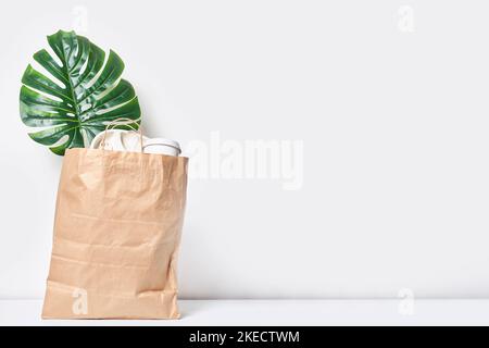 a plant in a brown paper bag on a white background, with copy space for your text or product label Stock Photo