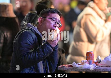 New Street, Birmingham, November 11th 2022. - Revellers enjoy a German bier and sausage on a very mild evening at the Birmingham Frankfurt Christmas Market as temperatures hover at 15 degrees. Pic by: Stop Press Media / Alamy Live News Stock Photo