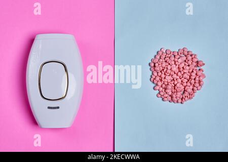 pink and white pills next to a urder on a blue and pink background, with a gold ring in the middle Stock Photo