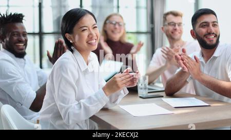 Diverse business team smiling to camera in office Stock Photo