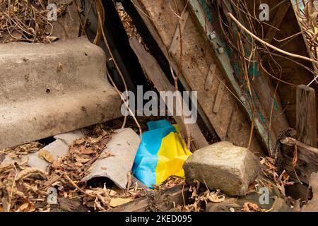 A residential building was blown up and the flag of Ukraine lies on the ruins of the house, the war and the shelling of Russian residential buildings Stock Photo
