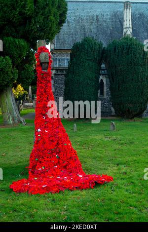 Beaconsfield, Buckinghamshire, UK. 11th November, 2022. Large knitted Remembrance Day poppy memorials in the grounds of the Parish Church of St Mary and All Saints in Beaconsfield, Buckinghamshire. Credit: Maureen McLean/Alamy Live News Stock Photo