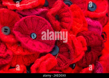 Beaconsfield, Buckinghamshire, UK. 11th November, 2022. Large knitted Remembrance Day poppy memorials in the grounds of the Parish Church of St Mary and All Saints in Beaconsfield, Buckinghamshire. Credit: Maureen McLean/Alamy Live News Stock Photo