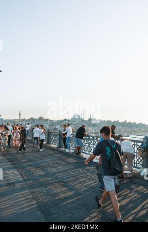 Travel to Istanbul. Tourists and citizens on the Galata Bridge. Istanbul Turkey - 8.20.2022 Stock Photo