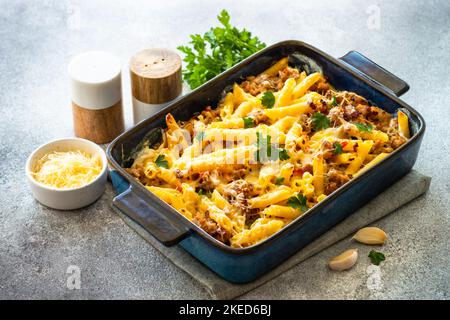Pasta penne with minced meat, cheese and creamy sauce. Stock Photo