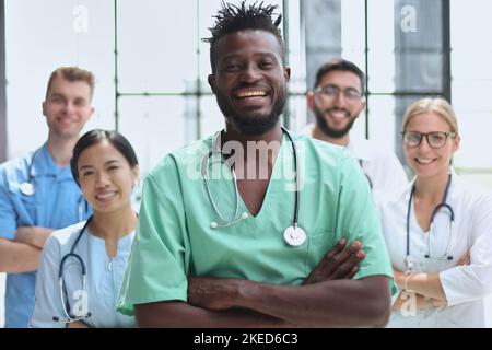 Smiling group of scientists in modern laboratory with male african american leader, mix race Stock Photo