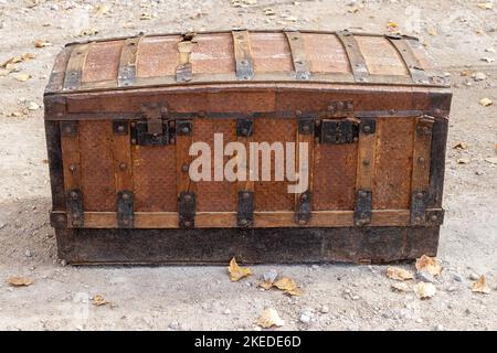 horizontal view of an old wooden travel trunk deteriorated by the passage of time. industry of antique restoration and travels Stock Photo