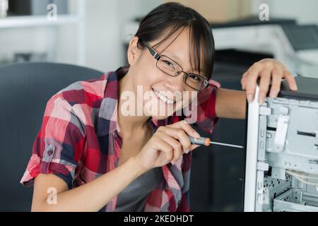 female computer technician using screwdriver Stock Photo