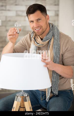 asian man changing light bulb in coffee shop Stock Photo - Alamy