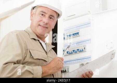 electrician working on design and installing circuit breakers Stock Photo