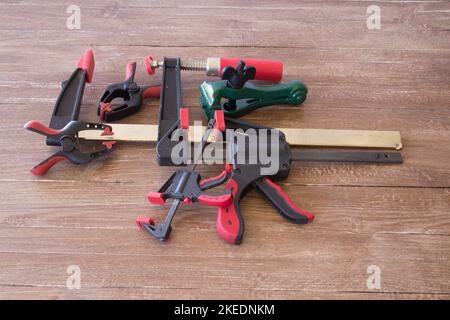 Image of clamps of various kinds and sizes for carpentry and blacksmith work. Stock Photo