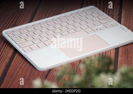 working with wireless external portable keyboard Stock Photo