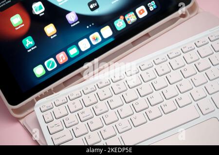 working with External portable wireless keyboard computer connected to tablet Stock Photo