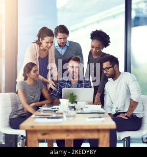 Theyre a team of over achievers. a group of colleagues working in their office. Stock Photo