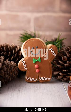 Christmas Homemade gingerbread man cookie waiving a hand saying hello, traditionally made at wintertime and the holidays. Stock Photo