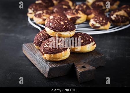 Shu Cake. Tasty profiterole with cream on the plate.  Copy space. Stock Photo