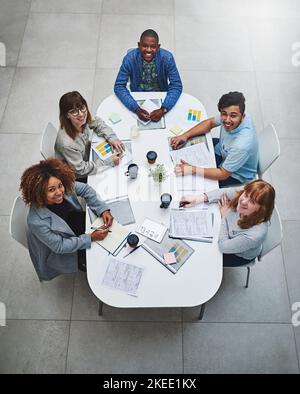 Making sure we do our part. High angle shot of a group of businesspeople having a meeting in an office. Stock Photo