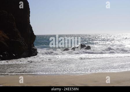 A grey whale cove on the beach close to the sandy area Stock Photo