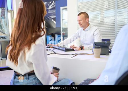 Young company employee receiving clients in his office Stock Photo