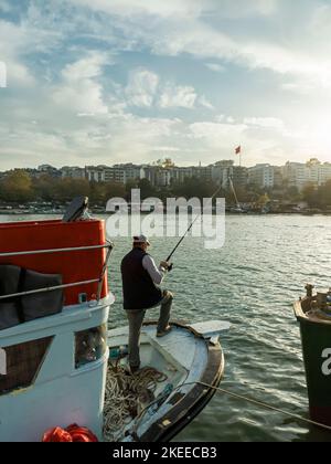 fisherman on a boat, fishing in the lake Stock Photo