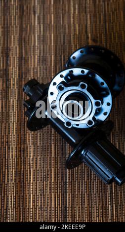 Bicycle front hub and rear hub on wooden background Stock Photo
