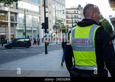 London- November 2022: Private Security patrolling Oxford Street where people are targeted for theft Stock Photo