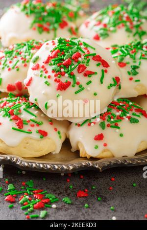 Italian Christmas Cookies are soft, buttery, fluffy with a hint of vanilla closeup in the plate on the table. Vertical Stock Photo
