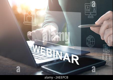 Webinar online. Hand use stylus Browsing webinar on laptop. Virtual learning concept. hand typing on laptop keyboard with Webinar homepage. online edu Stock Photo