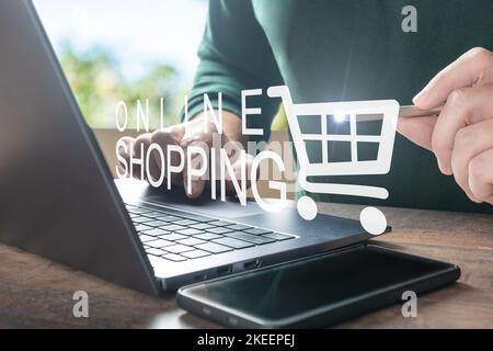 Online shopping. Order in online store, shopping on internet, concept on virtual screen with hands typing on keyboard. Men hands using laptop computer Stock Photo